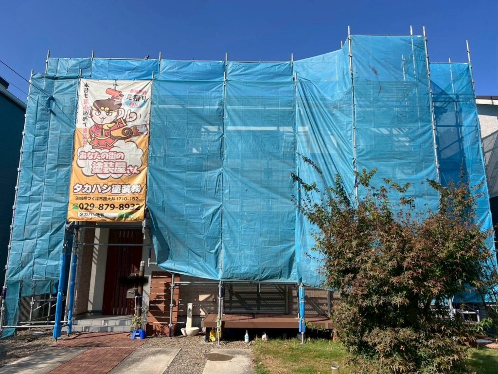 足場組立<br />
（塗料が飛散しないようにメッシュシートもしっかりと貼りました。）