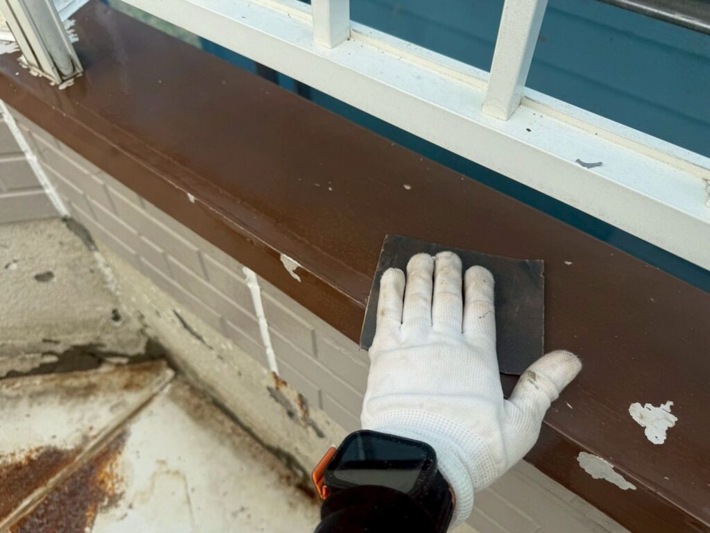 ベランダ笠木ケレン<br />
（ケレンとは、塗料との密着を良くするために、専用の道具にて細かい傷をつける下地調整です。）